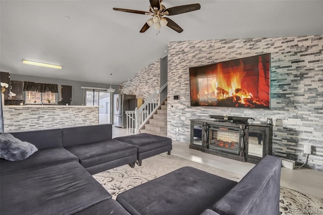 living room with ceiling fan and lofted ceiling