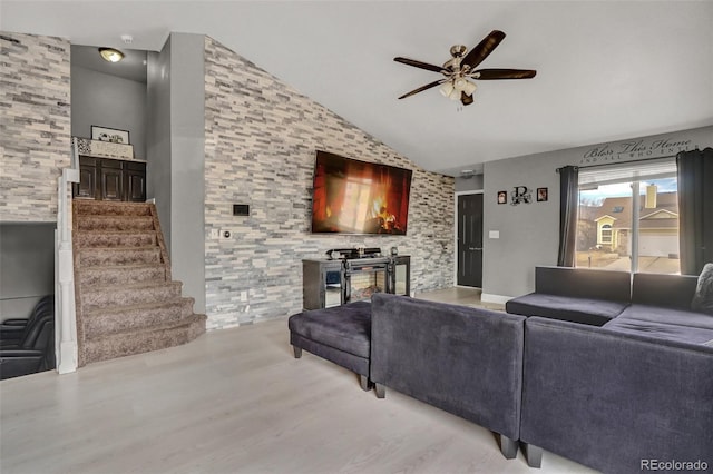 living room featuring ceiling fan, light hardwood / wood-style floors, and high vaulted ceiling