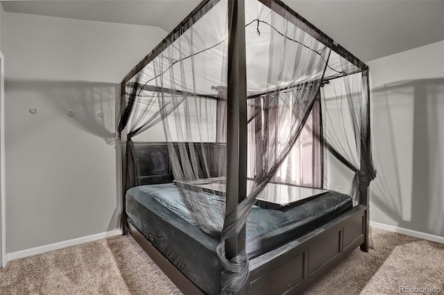 bedroom with carpet flooring and vaulted ceiling