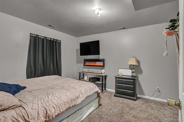 carpeted bedroom with a textured ceiling