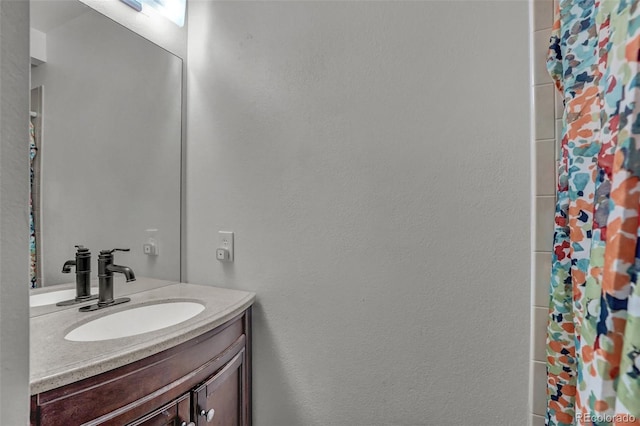 bathroom featuring vanity and walk in shower