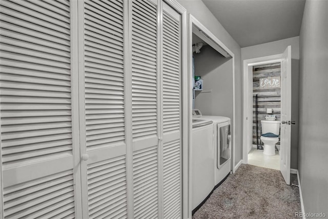 laundry area featuring washing machine and clothes dryer and light carpet