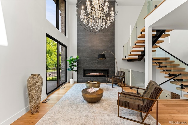 220 Glencoe St, Denver, CO 80220 - living area with a high ceiling, stairway, wood finished floors, baseboards, and a fireplace