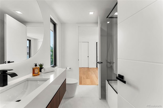 220 Glencoe St, Denver, CO 80220 - full bathroom with vanity, plenty of natural light, toilet, and tile patterned flooring
