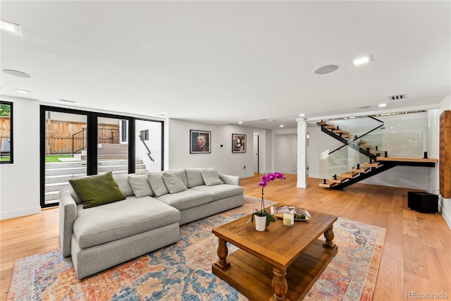 220 Glencoe St, Denver, CO 80220 - living room featuring stairs, light wood-style flooring, baseboards, and recessed lighting
