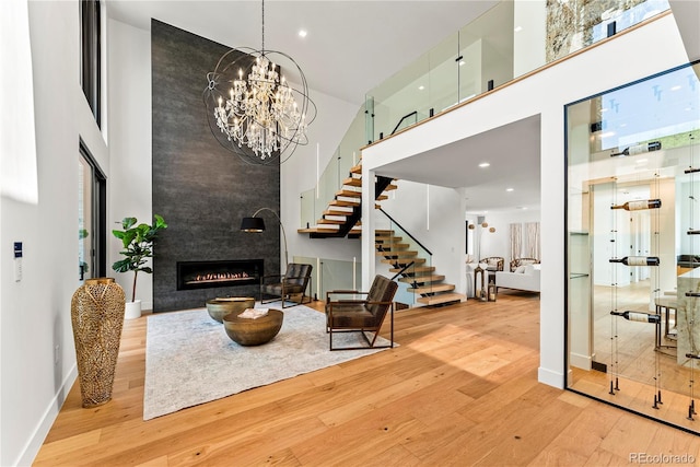 220 Glencoe St, Denver, CO 80220 - living room with a towering ceiling, hardwood / wood-style floors, a fireplace, stairs, and baseboards