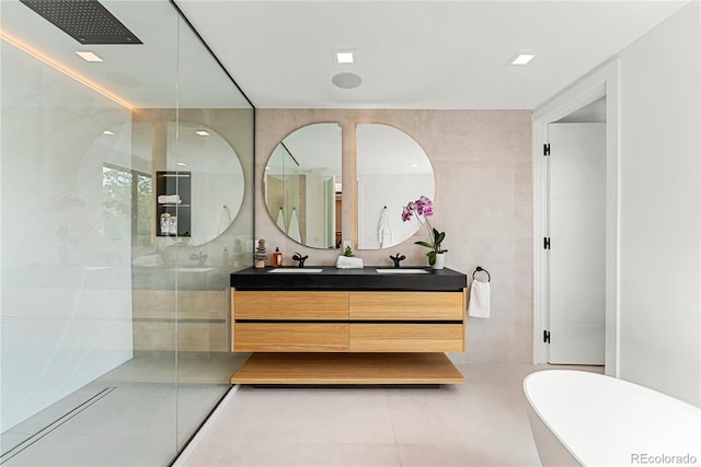 220 Glencoe St, Denver, CO 80220 - full bath featuring double vanity, walk in shower, tile walls, tile patterned floors, and a freestanding tub
