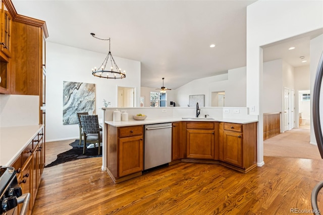 kitchen with brown cabinets, a sink, stainless steel dishwasher, light countertops, and stove