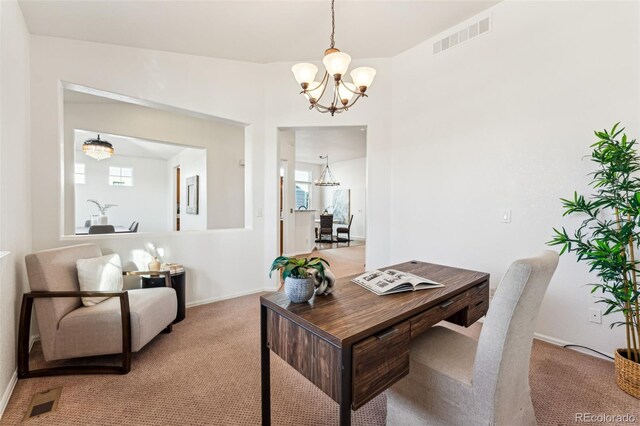 carpeted office space featuring an inviting chandelier, baseboards, and visible vents