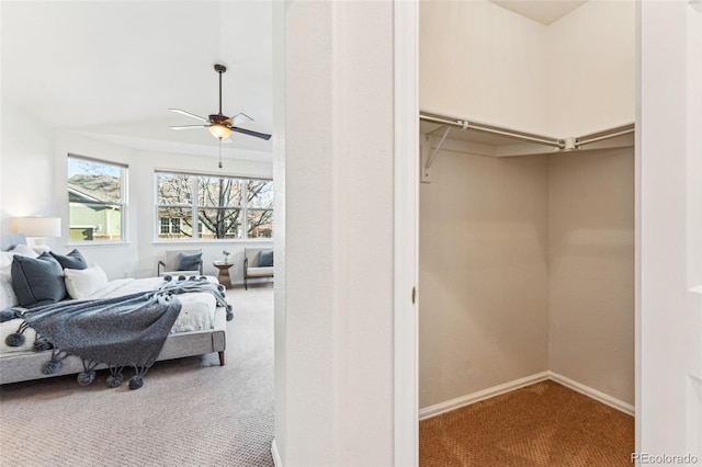 carpeted bedroom featuring ceiling fan and baseboards