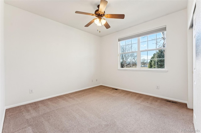 unfurnished room featuring visible vents, a ceiling fan, baseboards, and carpet floors