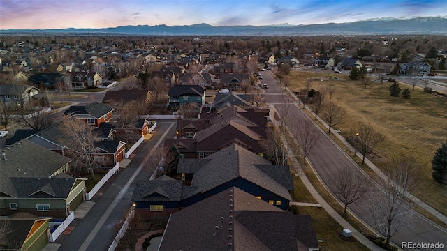 drone / aerial view featuring a residential view and a mountain view