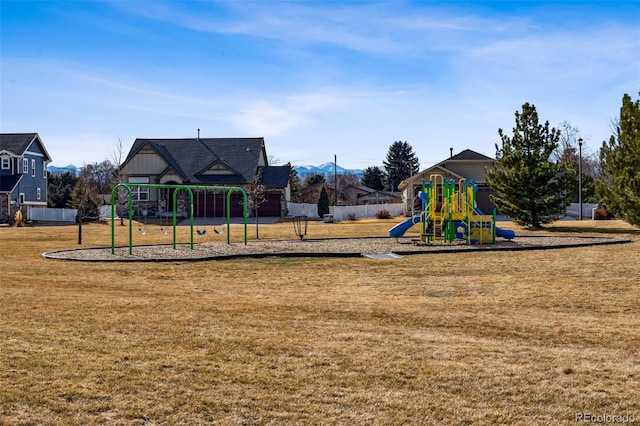 community jungle gym with a yard and fence