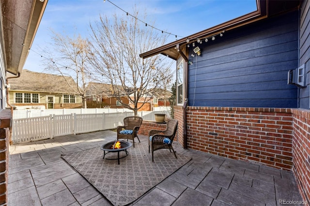 view of patio featuring a fire pit and fence