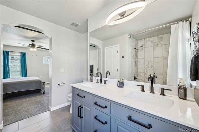 bathroom with visible vents, ceiling fan, a sink, and toilet