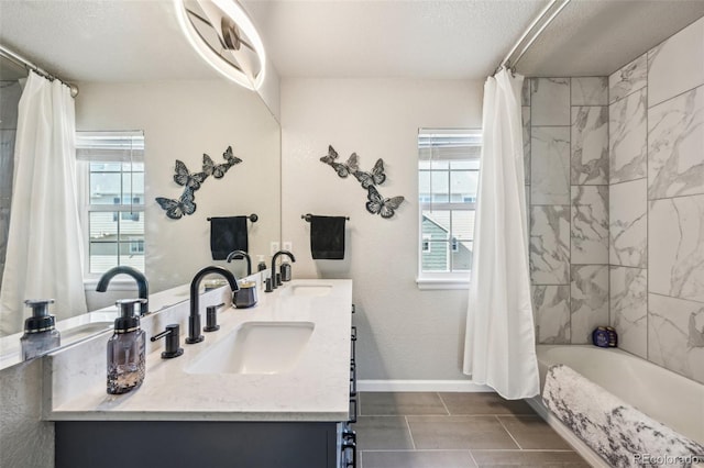 bathroom with a healthy amount of sunlight, a sink, and double vanity