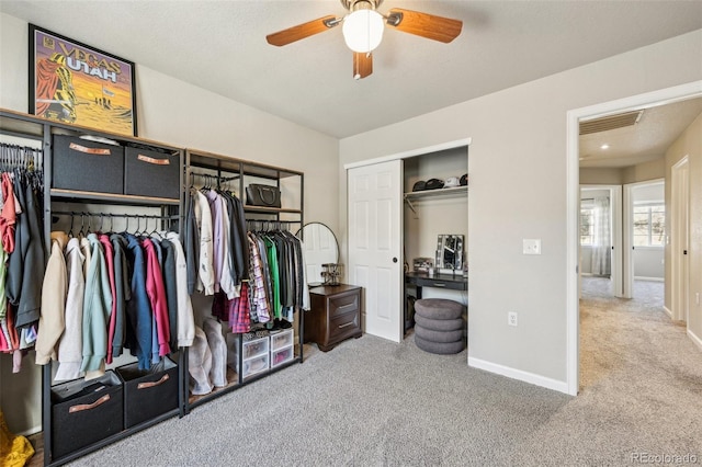 interior space with visible vents, carpet, and a ceiling fan