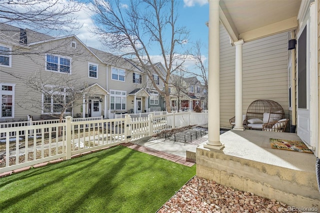 view of yard featuring a residential view and fence