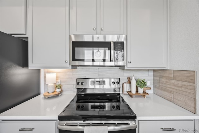 23633 E 5th Dr, Aurora, CO 80018 - kitchen featuring stainless steel appliances, tasteful backsplash, and light countertops