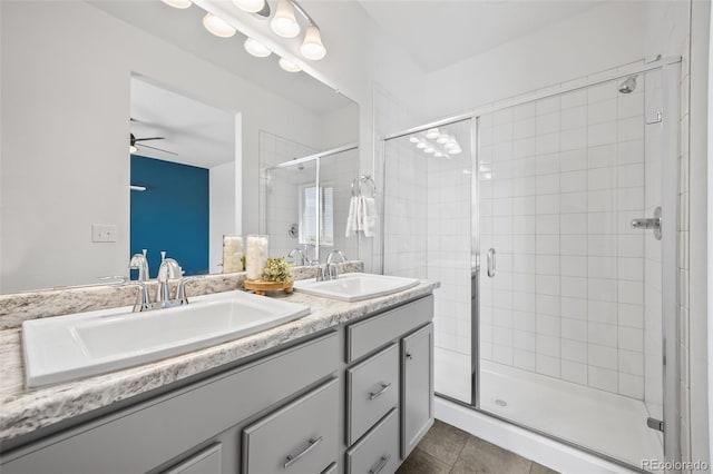 23633 E 5th Dr, Aurora, CO 80018 - bathroom with double vanity, a stall shower, a ceiling fan, and tile patterned flooring