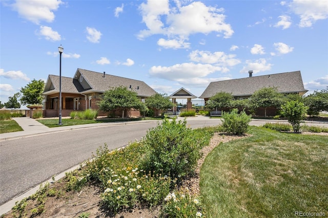23633 E 5th Dr, Aurora, CO 80018 - view of asphalt road featuring street lights, curbs, and sidewalks