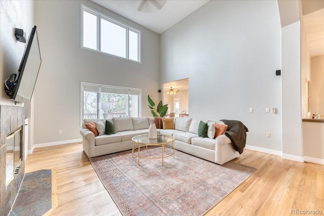 58 Rogers Ct, Golden, CO 80401 - living area featuring high vaulted ceiling, light wood-style floors, ceiling fan, and baseboards