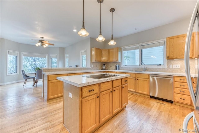 58 Rogers Ct, Golden, CO 80401 - kitchen featuring stainless steel appliances, a sink, tasteful backsplash, and light wood finished floors