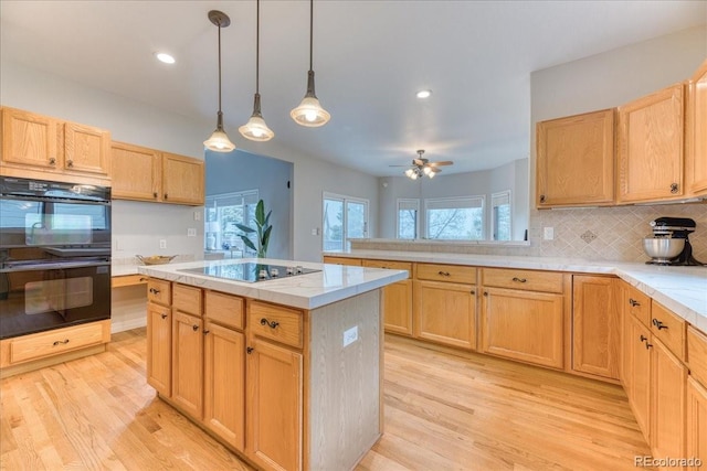 58 Rogers Ct, Golden, CO 80401 - kitchen featuring black appliances, light wood-type flooring, light countertops, backsplash, and recessed lighting