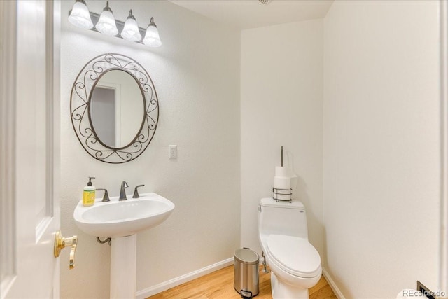 58 Rogers Ct, Golden, CO 80401 - bathroom featuring wood finished floors, toilet, and baseboards