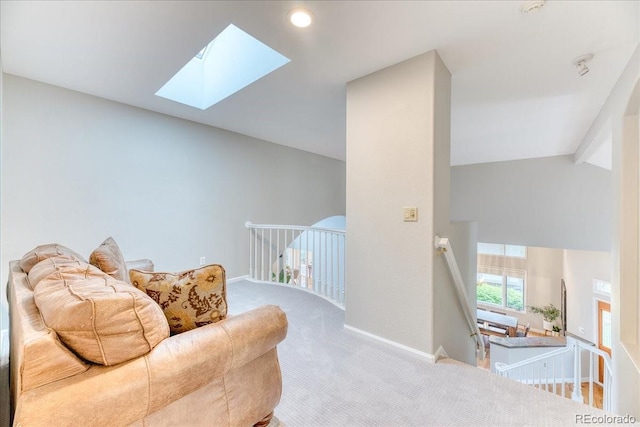 58 Rogers Ct, Golden, CO 80401 - sitting room with a skylight, carpet, baseboards, vaulted ceiling, and an upstairs landing