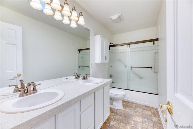 58 Rogers Ct, Golden, CO 80401 - bathroom with double vanity, bath / shower combo with glass door, and toilet