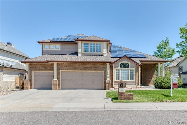 58 Rogers Ct, Golden, CO 80401 - view of front of house featuring roof mounted solar panels, brick siding, and driveway