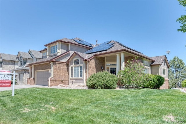 58 Rogers Ct, Golden, CO 80401 - view of front of house featuring brick siding, solar panels, a front lawn, and driveway