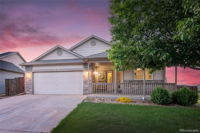 8617 W 17th Street Dr, Greeley, CO 80634 - single story home with a porch, concrete driveway, an attached garage, and stone siding