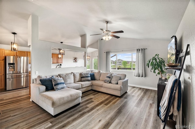 8617 W 17th Street Dr, Greeley, CO 80634 - living area with lofted ceiling, wood finished floors, ceiling fan, and baseboards