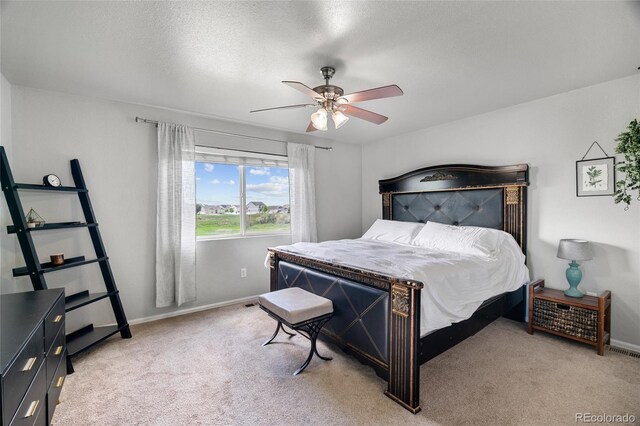 8617 W 17th Street Dr, Greeley, CO 80634 - bedroom featuring light carpet, baseboards, ceiling fan, and a textured ceiling