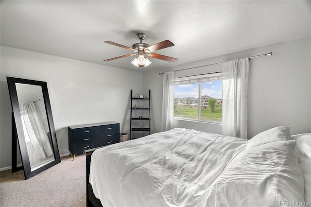 8617 W 17th Street Dr, Greeley, CO 80634 - bedroom with light carpet, a ceiling fan, and baseboards