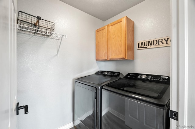 8617 W 17th Street Dr, Greeley, CO 80634 - laundry area featuring washing machine and dryer, cabinet space, and a textured wall
