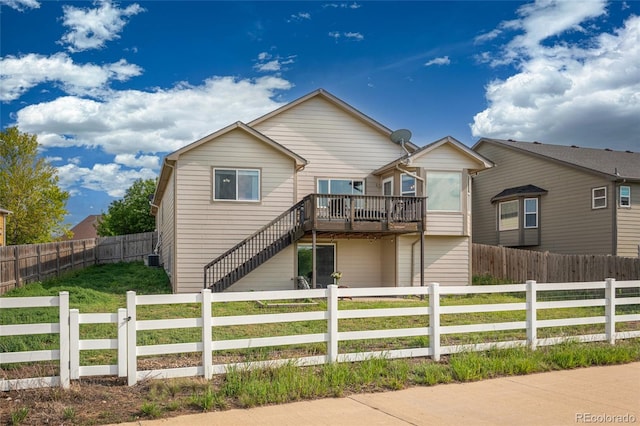 8617 W 17th Street Dr, Greeley, CO 80634 - view of front of house featuring a deck, a fenced front yard, stairway, and central AC unit