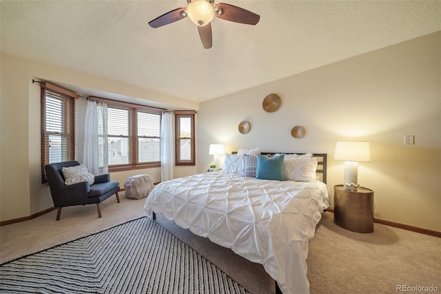 carpeted bedroom with a textured ceiling, ceiling fan, and lofted ceiling