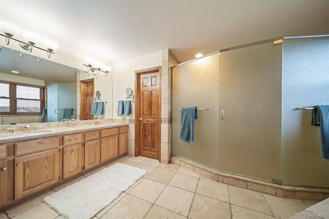 bathroom with vanity and a shower with door