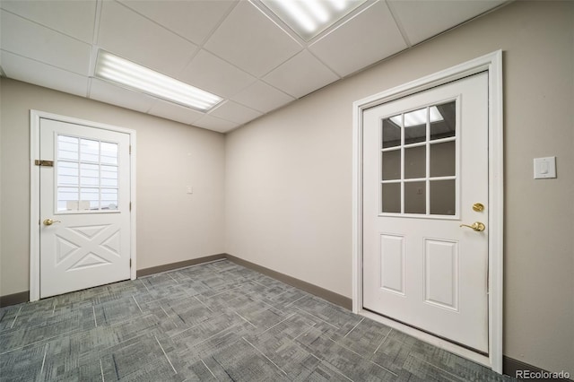 spare room with carpet floors and a drop ceiling