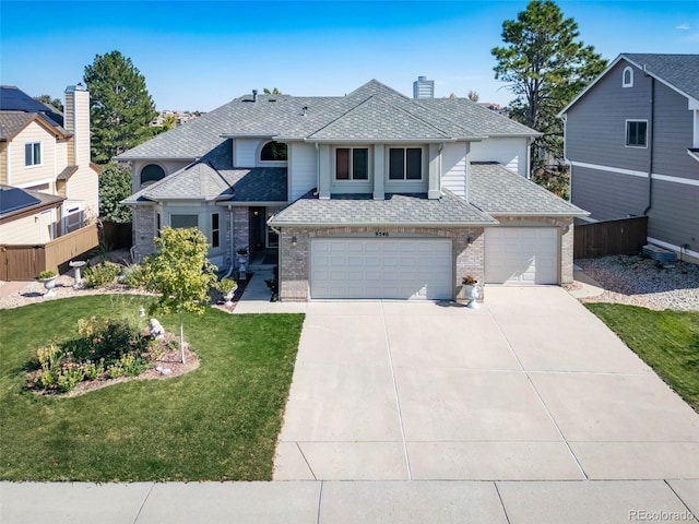 view of property featuring a front yard and a garage