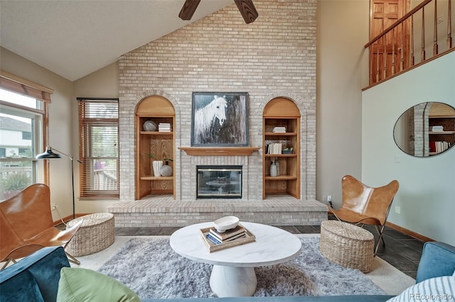 living room with tile patterned floors, ceiling fan, high vaulted ceiling, built in features, and a fireplace