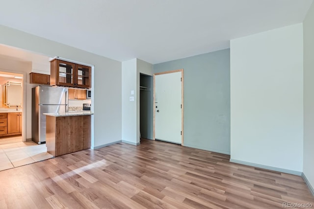 kitchen featuring sink, light wood-type flooring, and stainless steel appliances