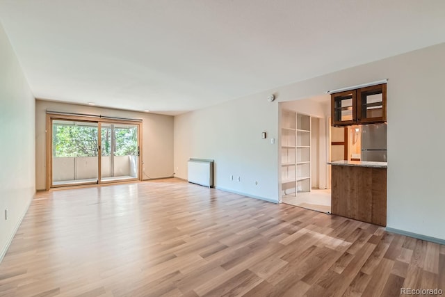 unfurnished living room with light hardwood / wood-style floors