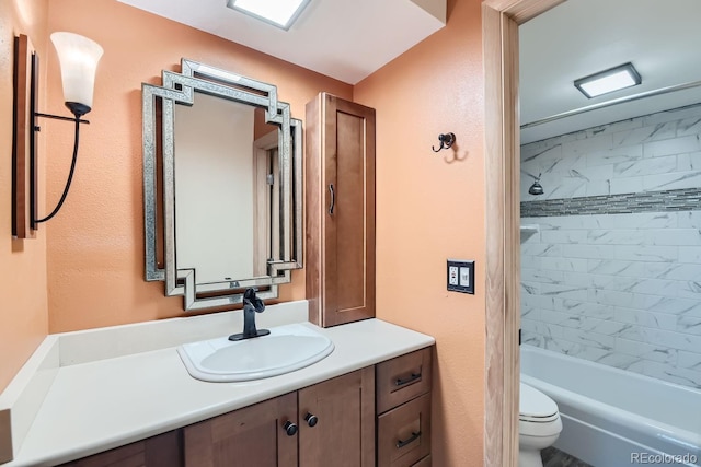 bathroom with bathtub / shower combination, vanity, and toilet