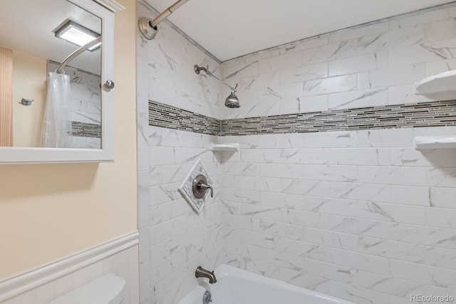 bathroom featuring shower / tub combo with curtain and toilet