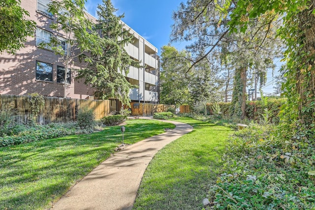 view of property's community featuring a yard