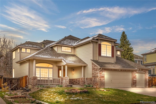 view of front of home featuring driveway, a shingled roof, covered porch, an attached garage, and fence